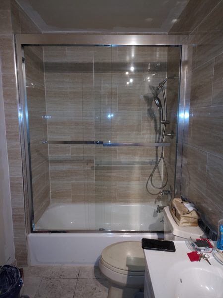 Tiled Tub & Glass Doors — Bathrooms project by NC Total Construction