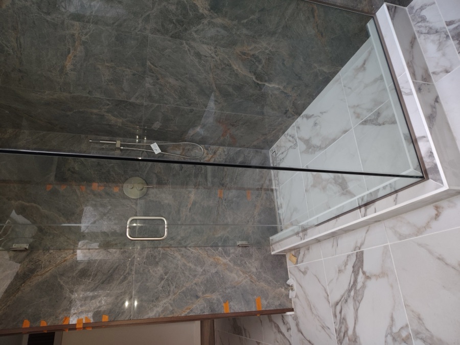 Custom marble walk-in glass shower bathroom remodel by NC Total Construction
